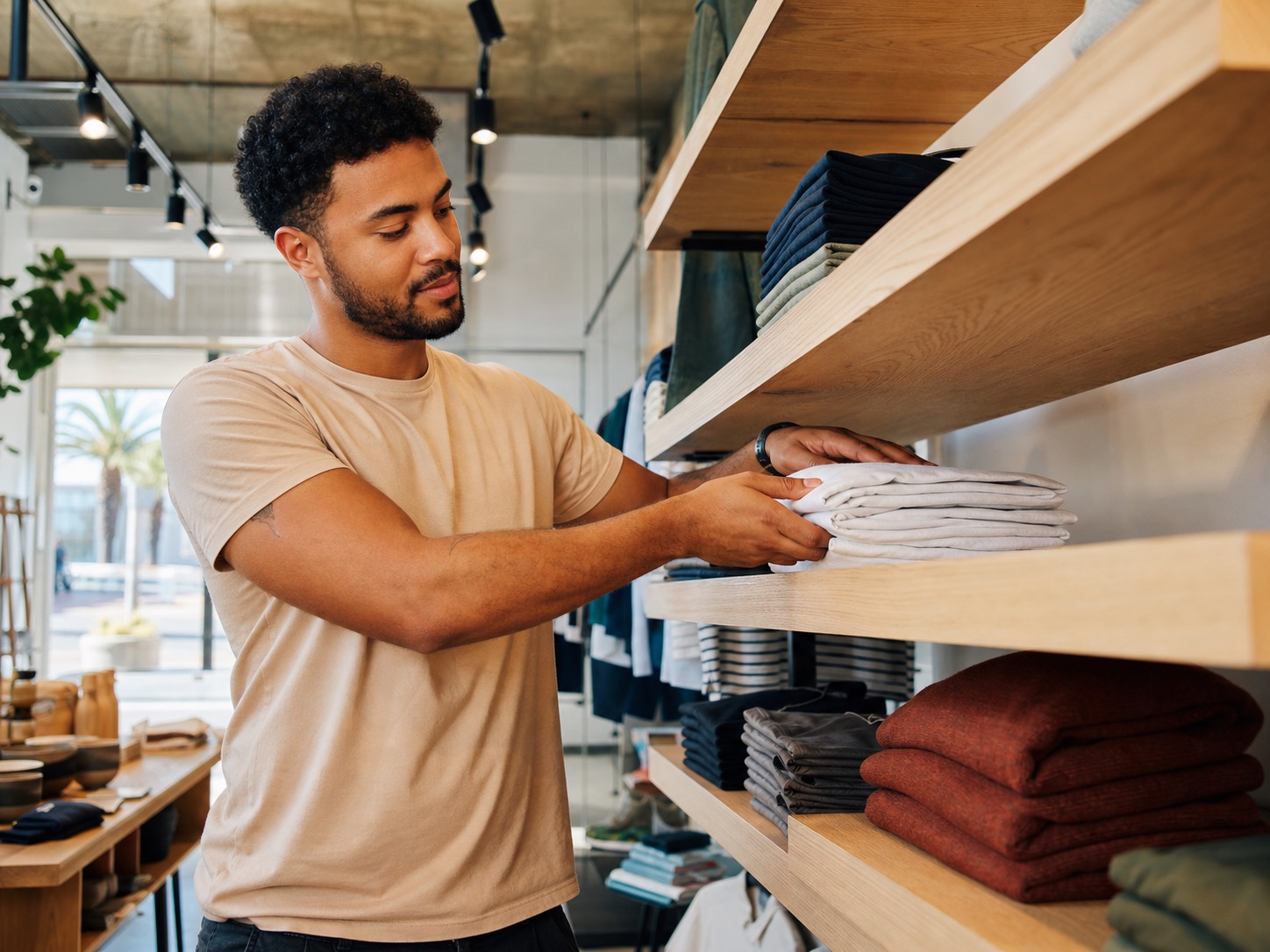 Retail shop owner arranging inventory